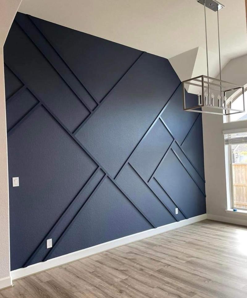 Navy geometric accent wall with crisp white baseboards